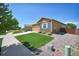 Exterior front yard view of home with green lawn and rock landscaping at 7433 Ellingwood Cir, Frederick, CO 80504