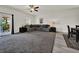 Spacious living room featuring plush carpeting, a gray sectional, neutral walls, and access to the outdoor living space at 7433 Ellingwood Cir, Frederick, CO 80504