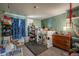 A charming bedroom with carpeted floors, green walls, and blue curtains at 2699 S Xanadu Way # A, Aurora, CO 80014