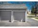 View of the exterior of garages; two individual garages are connected with parking area at 2699 S Xanadu Way # A, Aurora, CO 80014