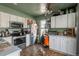 Charming kitchen with white cabinetry, stainless steel appliances, and wood look flooring at 2699 S Xanadu Way # A, Aurora, CO 80014
