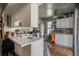 Efficient kitchen featuring white cabinets, countertops, and modern appliances, providing a functional cooking space at 2699 S Xanadu Way # A, Aurora, CO 80014