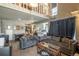 Open-concept living area with soaring ceilings, a cozy seating area, and a view of the adjacent kitchen at 2699 S Xanadu Way # A, Aurora, CO 80014