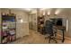 Finished loft with neutral walls, comfortable seating, shelving, and unique lighting at 2699 S Xanadu Way # A, Aurora, CO 80014