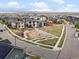 Neighborhood aerial view showcasing a park, playground, and modern homes with mountain views in the distance at 9378 E 60Th Pl, Denver, CO 80238