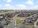 Community aerial view featuring modern homes, green spaces, and scenic views, offering a vibrant neighborhood at 9378 E 60Th Pl, Denver, CO 80238