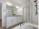 Bright bathroom features a glass enclosed shower, soaking tub, and a double vanity at 9378 E 60Th Pl, Denver, CO 80238
