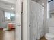 Modern bathroom with a tiled shower, toilet, and doorway to an adjoining bedroom at 9378 E 60Th Pl, Denver, CO 80238