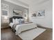 Elegant bedroom with a king-sized bed, soft lighting, and stylish decor at 9378 E 60Th Pl, Denver, CO 80238