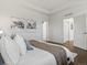 Bright bedroom with white walls, hardwood floors, stylish art, and a cozy bed at 9378 E 60Th Pl, Denver, CO 80238