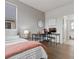 Bedroom featuring a desk area, hardwood floors, and a pink accent blanket at 9378 E 60Th Pl, Denver, CO 80238