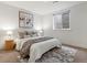Bright bedroom with a comfortable bed, plush bedding, and a stylish rug, creating a cozy retreat at 9378 E 60Th Pl, Denver, CO 80238