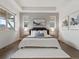 Spacious bedroom featuring a king bed, tray ceiling, and contemporary decor at 9378 E 60Th Pl, Denver, CO 80238