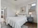 Cozy bedroom with hardwood floors, neutral walls, and a picture window at 9378 E 60Th Pl, Denver, CO 80238