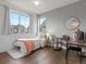 Bedroom with two large windows, a full desk, and an overhead fan at 9378 E 60Th Pl, Denver, CO 80238