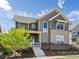 Charming two-story home features stone accents, a covered porch, and a well-maintained front yard at 9378 E 60Th Pl, Denver, CO 80238