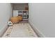 Hallway with a rug, cube storage, and two round woven ottomans at 9378 E 60Th Pl, Denver, CO 80238