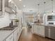 Modern kitchen with gas range, stainless appliances, and ample counter space in an open layout at 9378 E 60Th Pl, Denver, CO 80238