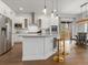 Bright, modern kitchen features stainless appliances, white cabinetry, and a large center island at 9378 E 60Th Pl, Denver, CO 80238