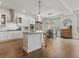 Bright modern kitchen features an island, stainless appliances, and open dining area at 9378 E 60Th Pl, Denver, CO 80238