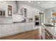 Well-equipped kitchen features white cabinets, stainless steel appliances, and tiled backsplash at 9378 E 60Th Pl, Denver, CO 80238