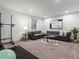 Spacious living room featuring a gray sectional sofa, neutral color palette, and plush carpet, perfect for relaxation at 9378 E 60Th Pl, Denver, CO 80238
