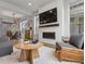 Open-concept living room featuring a fireplace, mounted TV, and modern decor at 9378 E 60Th Pl, Denver, CO 80238