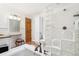 Bathroom featuring glass block shower, tub, and vanity with a small sitting area at 2222-2224 Hooker St, Denver, CO 80211