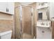 Bathroom featuring a glass shower with tan tile, vanity and a three bulb light fixture at 2222-2224 Hooker St, Denver, CO 80211