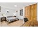 Bedroom features a light wood floor with a desk and a view out of a window at 2222-2224 Hooker St, Denver, CO 80211