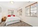 Cozy bedroom with neutral carpet and three bright windows that have wooden blinds at 2222-2224 Hooker St, Denver, CO 80211