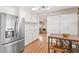 Bright kitchen featuring white cabinets, stainless steel appliances, and light hardwood floors at 2222-2224 Hooker St, Denver, CO 80211