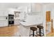 Bright kitchen featuring white cabinets, stainless steel appliances, and light hardwood floors at 2222-2224 Hooker St, Denver, CO 80211