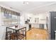 Well-lit kitchen with stainless steel appliances, a breakfast table, and hardwood floors at 2222-2224 Hooker St, Denver, CO 80211