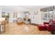 Bright living room with hardwood floors, a cozy sofa, and a door leading outside at 2222-2224 Hooker St, Denver, CO 80211