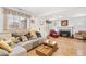 Inviting living room with a cozy sofa, fireplace, and large windows for natural light at 2222-2224 Hooker St, Denver, CO 80211
