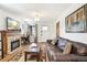 Comfortable living room has a stone fireplace and a large leather couch at 2222-2224 Hooker St, Denver, CO 80211