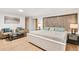 Spacious main bedroom featuring a platform bed, light wood floors, and two leather chairs at 2222-2224 Hooker St, Denver, CO 80211