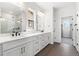 Bright bathroom featuring double vanity, large shower with glass door, and neutral color palette at 8903 Springsong Ln, Littleton, CO 80125