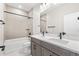 Bright bathroom with double vanity, modern fixtures, and a tiled shower-tub combination at 8903 Springsong Ln, Littleton, CO 80125