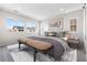 Well-lit bedroom with three large windows, soft carpet, and modern decor at 8903 Springsong Ln, Littleton, CO 80125