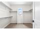 Walk-in closet featuring built-in shelving and a window with a view at 8903 Springsong Ln, Littleton, CO 80125