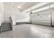 Spacious unfinished garage with door leading to the house at 8903 Springsong Ln, Littleton, CO 80125