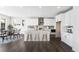 Open concept kitchen with white cabinets, stainless appliances, an island with seating, and dining area at 8903 Springsong Ln, Littleton, CO 80125