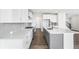 Beautiful kitchen features stainless steel appliances, an island with seating, and sleek white cabinets at 8903 Springsong Ln, Littleton, CO 80125