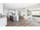 Modern kitchen with an island, hardwood floors, white cabinetry, and stainless steel appliances at 8903 Springsong Ln, Littleton, CO 80125
