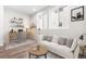Cozy living room featuring modern sofa, desk, and large windows for natural light at 8903 Springsong Ln, Littleton, CO 80125