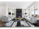 Bright living room featuring modern fireplace, large windows, neutral furniture and stylish accent rug at 8903 Springsong Ln, Littleton, CO 80125