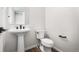 Clean powder room featuring modern sink, black fixtures, and a simple yet stylish design at 8903 Springsong Ln, Littleton, CO 80125