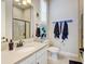 Modern bathroom featuring neutral tones, a glass-enclosed shower, and a vanity with sleek fixtures at 8000 Gore Creek Ln, Littleton, CO 80125